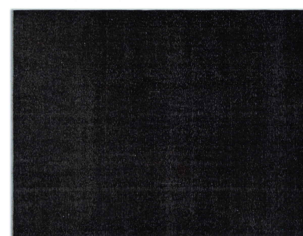 Solid black rug with a subtle, distressed vintage texture.