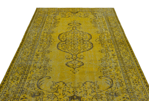 Load image 1 in gallery view. Distressed mustard yellow rug with a dark brown central medallion and ornate floral border on a white background.