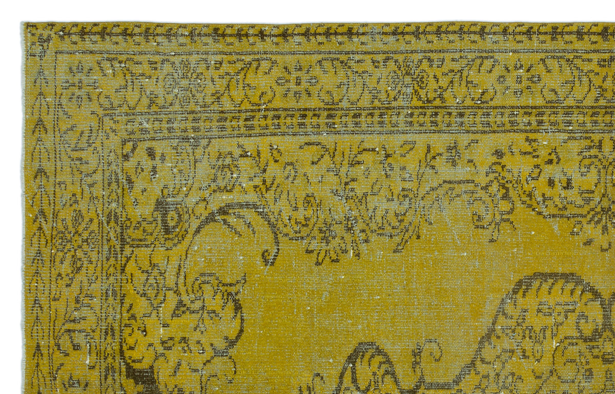 Mustard yellow rug with a distressed brown traditional floral border and ornate central medallion pattern.