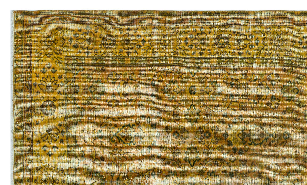 Mustard yellow and olive green vintage-style rug with a traditional floral medallion border and intricate vine pattern.
