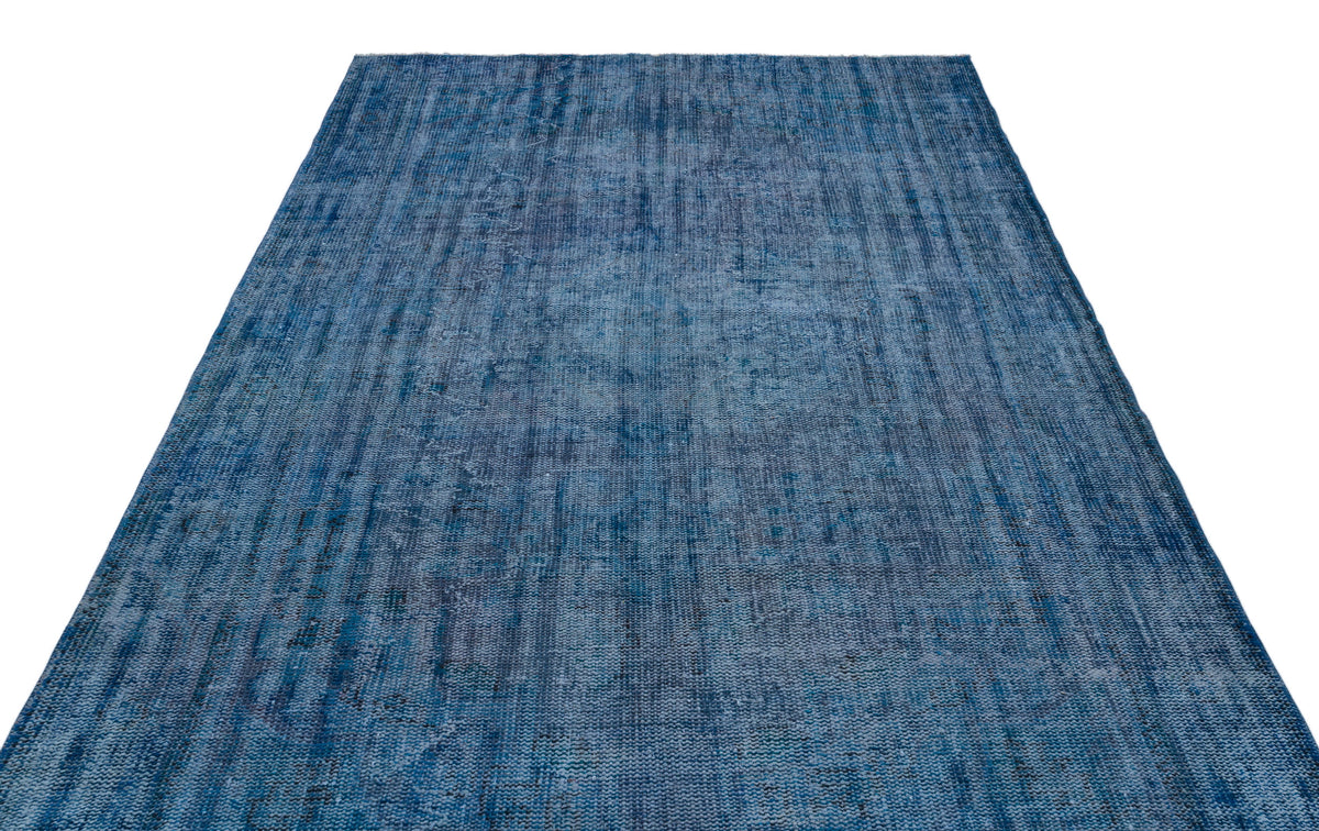 Blue distressed-style rug with a textured, monochromatic abstract pattern on a white background.