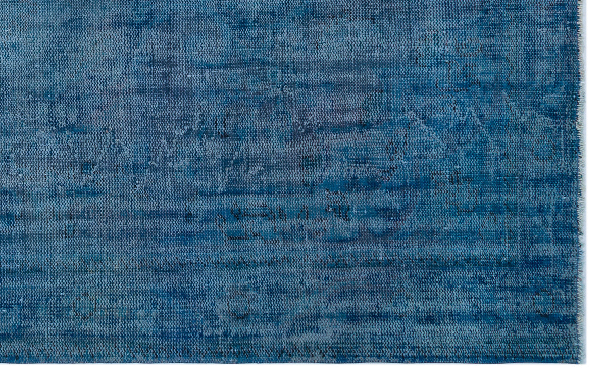 Deep blue distressed rug with a textured, horizontal linear pattern and a fringed edge on a white background.