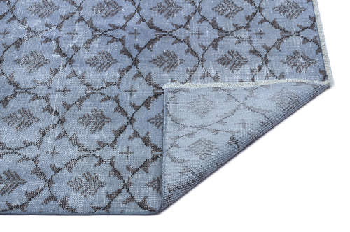 Load image 1 in gallery view. Light blue rug with a dark grey trellis and floral pattern, featuring a folded corner showing the woven backing.