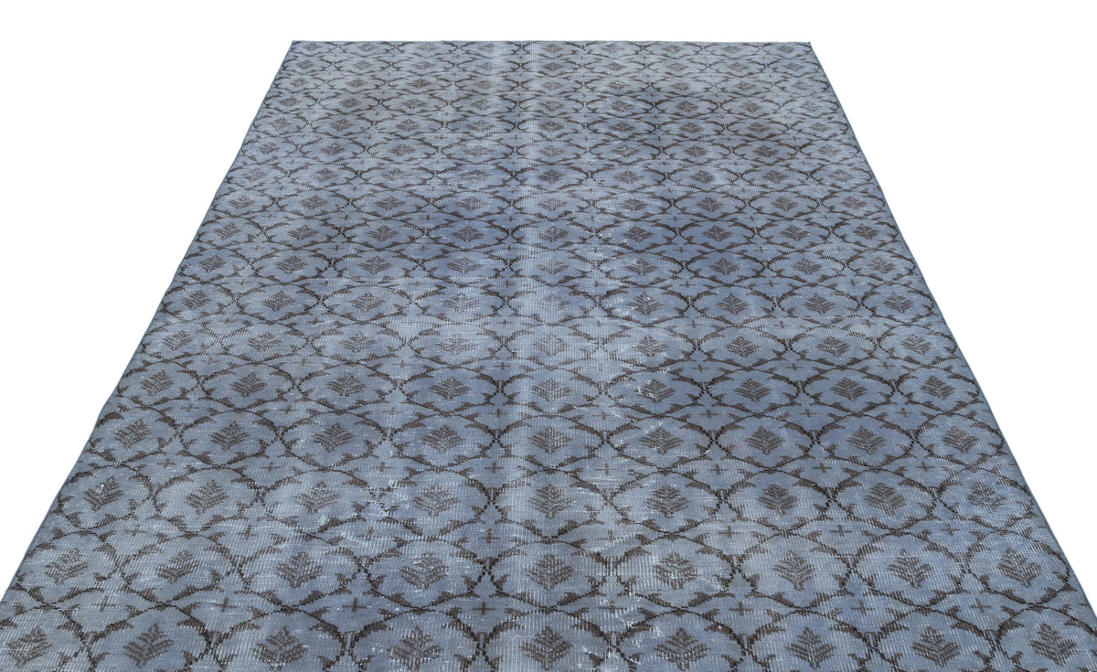Blue and grey distressed rug with a repeating geometric lattice pattern on a white background.