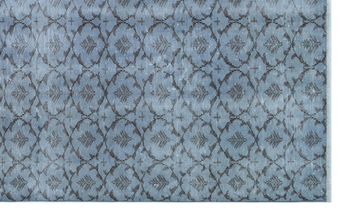 Load image 1 in gallery view. Slate blue rug with a distressed charcoal grey trellis pattern and repeating floral motifs.
