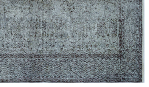 Load image 1 in gallery view. Grey and charcoal distressed rug with a faded traditional floral medallion pattern and a dark geometric border.