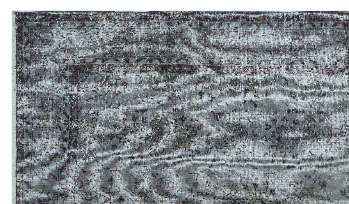 Charcoal and grey distressed rug with a traditional floral medallion border and faded vintage-style pattern.