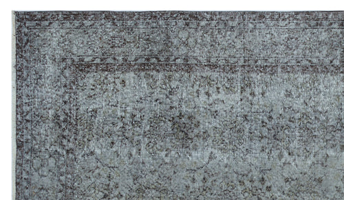 Load image 1 in gallery view. Charcoal and grey distressed rug with a traditional floral medallion border and faded vintage-style pattern.
