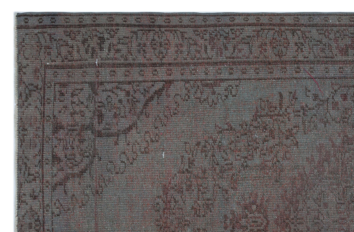 Charcoal and dark red rug with a traditional ornate floral border and central medallion pattern.