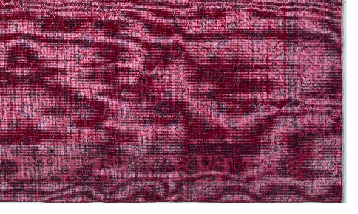 Deep magenta vintage-style rug with a distressed floral medallion pattern and a dark ornate border.