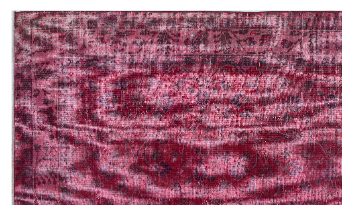 Deep red vintage-style rug with a dark floral border and a distressed, faded botanical pattern.
