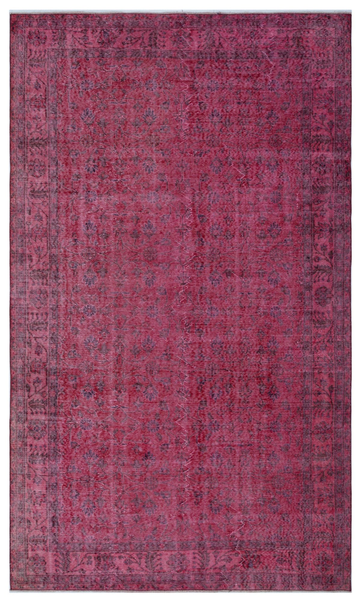 Magenta and dark purple vintage-style rug with a faded floral medallion pattern and a decorative border.