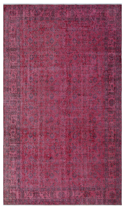 Load image 1 in gallery view. Magenta and dark purple vintage-style rug with a faded floral medallion pattern and a decorative border.