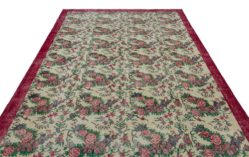 Load image 1 in gallery view. Cream rug with a red border and a repeating floral pattern in shades of red, green, and blue.