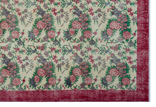 Load image 1 in gallery view. Cream rug with a floral pattern in pink, green, and blue, featuring a wide, distressed red border.