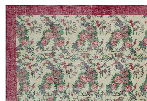 Load image 1 in gallery view. Cream rug with a distressed floral pattern in red, green, and blue, featuring a wide red border.