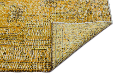 Load image 1 in gallery view. Mustard yellow and brown distressed traditional rug with a folded corner, isolated on a white background.