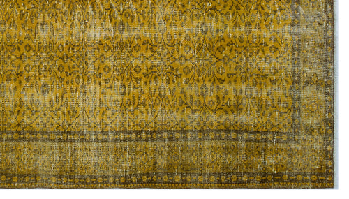 Load image 1 in gallery view. Mustard yellow and brown distressed rug with a traditional floral medallion pattern and a geometric border.