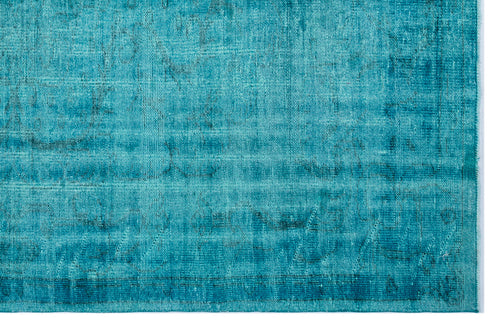 Load image 1 in gallery view. Teal distressed vintage-style rug with a faded, textured pattern and a visible woven border.