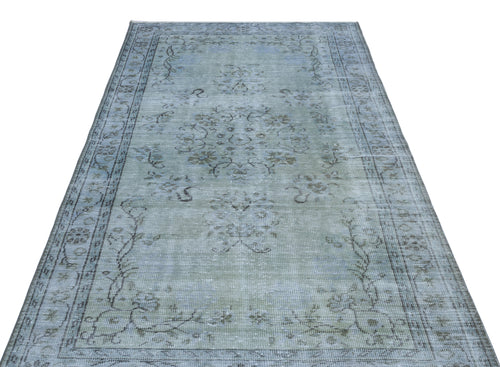 Load image 1 in gallery view. Distressed light blue and grey area rug with a faded central floral medallion and ornate border pattern.