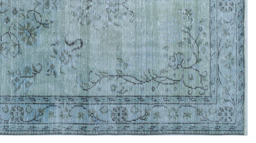 Load image 1 in gallery view. Distressed sage green rug with a faded floral medallion pattern and a dark grey geometric border.