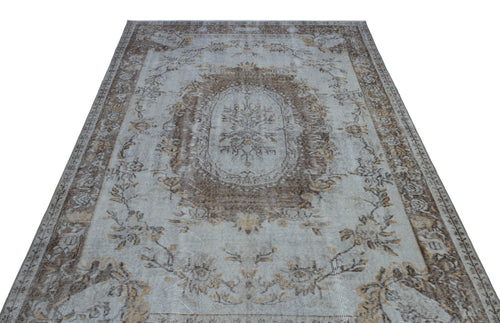 Load image 1 in gallery view. Light blue and brown distressed rug with a central floral medallion and ornate border pattern.