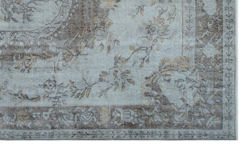 Load image 1 in gallery view. Light blue and brown rug with a distressed floral medallion pattern and a decorative border.
