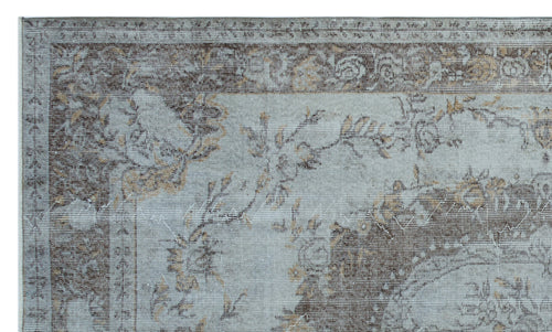 Load image 1 in gallery view. Light blue and brown distressed rug with a traditional floral medallion pattern and a wide decorative border.
