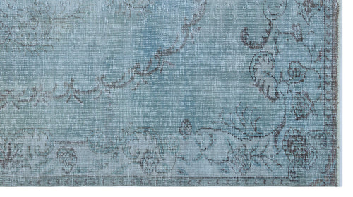 Load image 1 in gallery view. Light blue distressed rug with a faded brown floral medallion pattern on a white background.