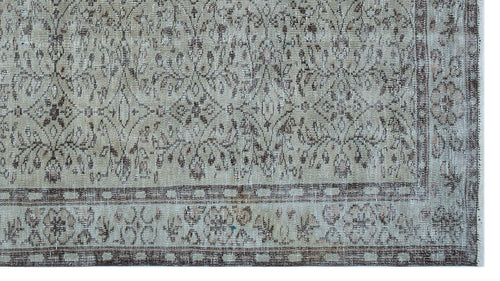 Load image 1 in gallery view. Beige and brown distressed vintage-style rug with a traditional floral medallion pattern and a geometric border.