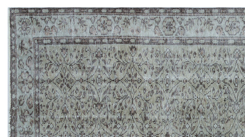 Load image 1 in gallery view. Distressed taupe and grey rug with a traditional floral medallion pattern and a geometric border.