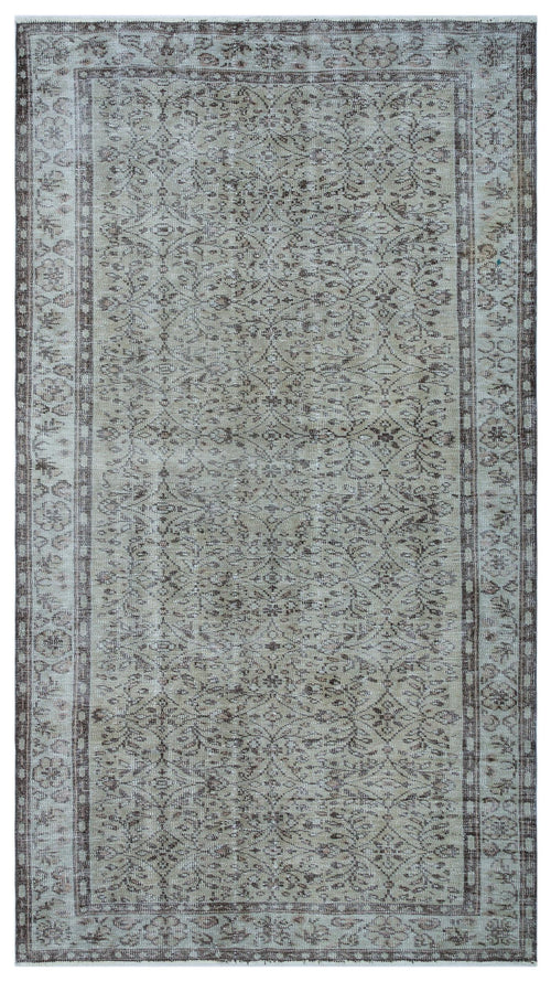 Load image 1 in gallery view. Beige and brown vintage-style rug with a distressed floral medallion pattern and a decorative border.