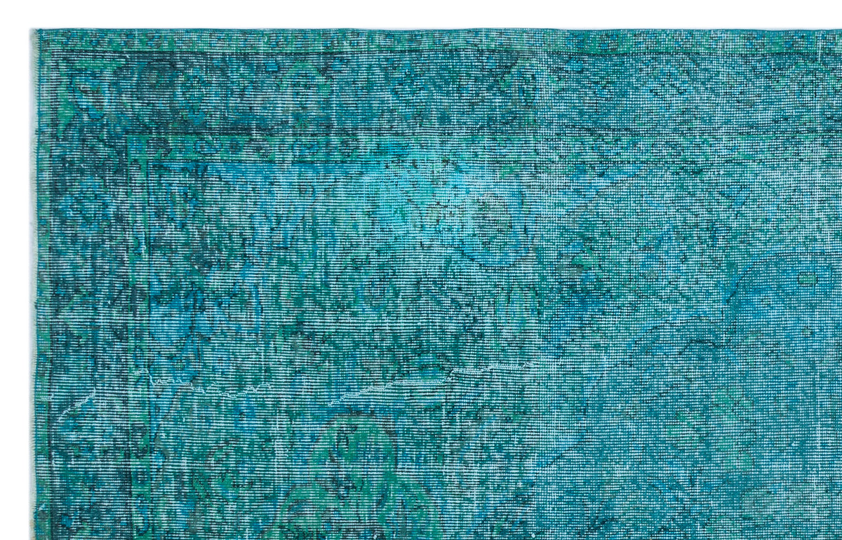 Teal and turquoise distressed rug with a faded traditional medallion pattern on a white background.