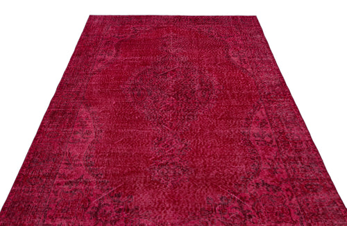 Load image 1 in gallery view. Deep red vintage-style rug with a faded, intricate central medallion pattern on a white background.