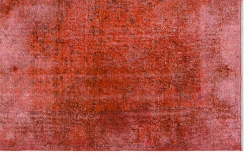 Load image 1 in gallery view. Distressed red and pink overdyed rug with a faint, traditional medallion pattern.