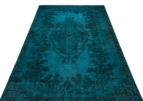 Load image 1 in gallery view. Teal and black distressed rug with a traditional floral medallion pattern on a white background.
