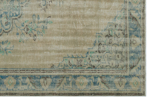 Load image 1 in gallery view. Beige and blue distressed rug with a faded traditional floral medallion pattern and a decorative border.