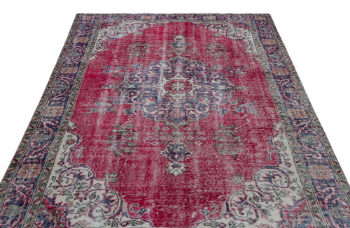 Load image 1 in gallery view. Distressed red vintage-style rug with a central blue and cream floral medallion and ornate border.