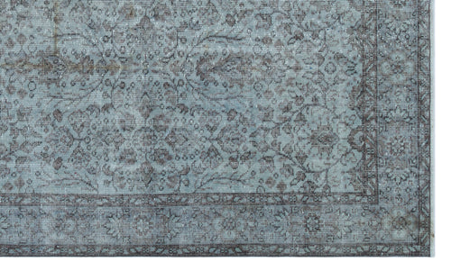 Load image 1 in gallery view. Distressed blue and charcoal grey rug with a traditional floral medallion pattern and a detailed border.
