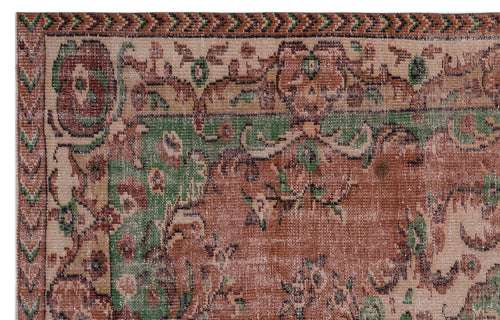 Load image 1 in gallery view. Distressed terracotta and green traditional rug with a floral medallion pattern and geometric border.