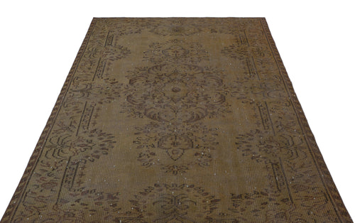 Load image 1 in gallery view. Distressed brown vintage rug with a central floral medallion and ornate border pattern on a white background.
