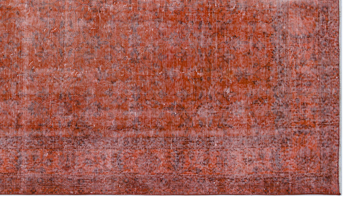 Rust-colored rug with a distressed, faded texture and subtle dark brown mottled detailing.