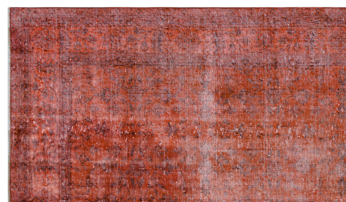 Rust-colored vintage-style rug with a distressed, faded texture and subtle dark tonal variations.