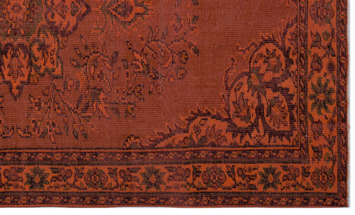 Load image 1 in gallery view. Rust-colored rug with a dark brown traditional floral medallion pattern and a geometric border.