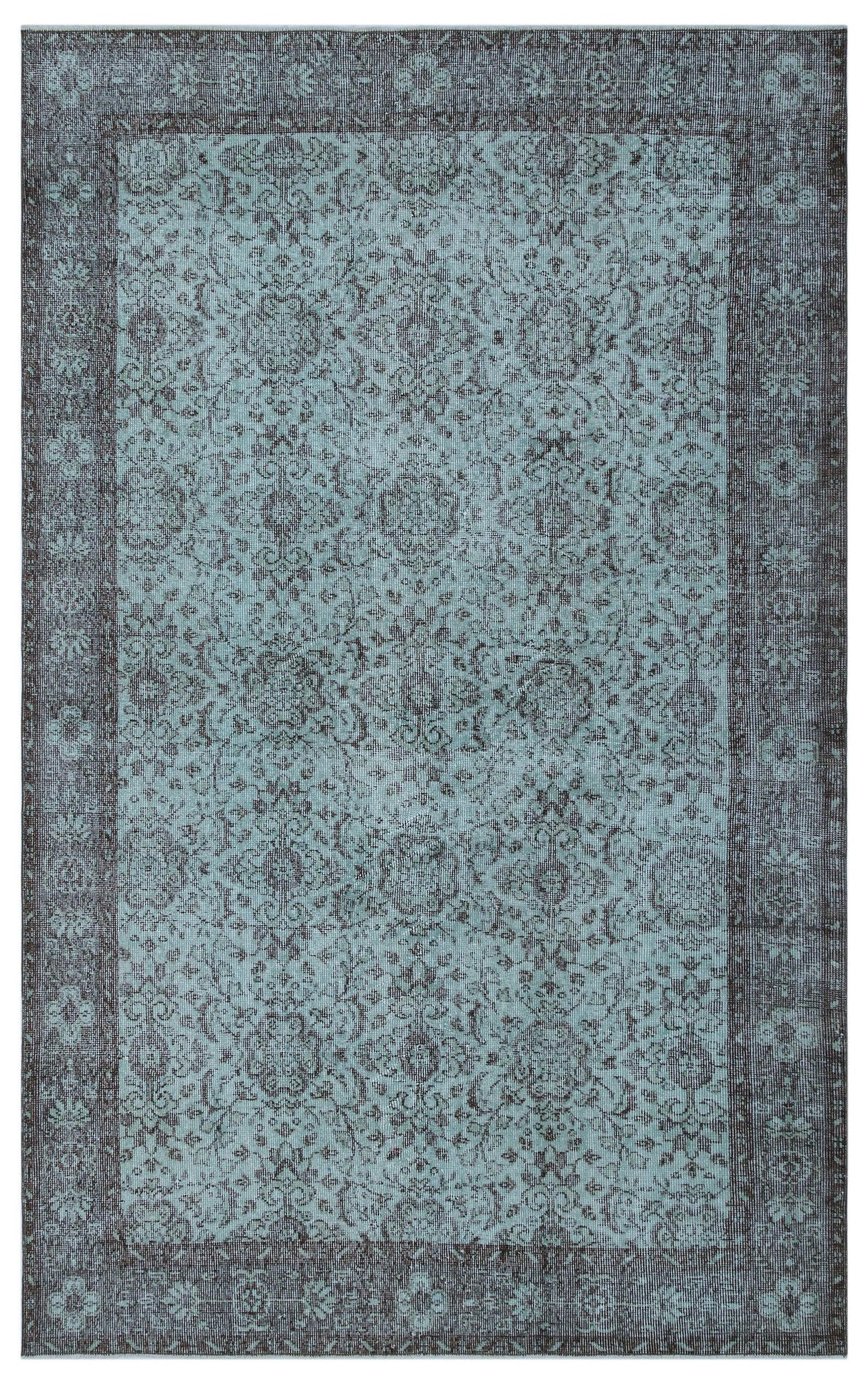 Teal and charcoal distressed rug with a traditional floral medallion pattern and a wide decorative border.