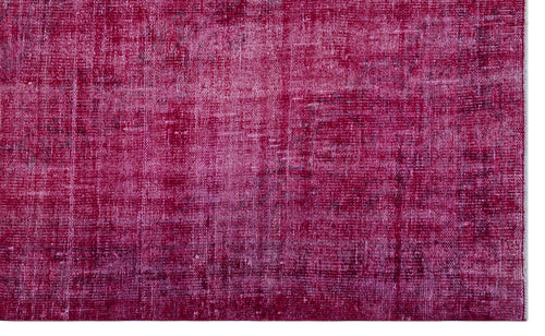 Load image 1 in gallery view. Magenta and dark pink distressed overdyed rug with a faded, textured vintage pattern.