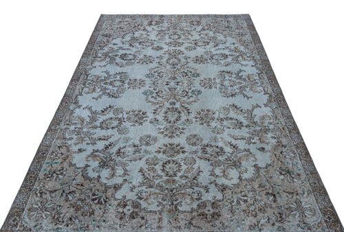 Load image 1 in gallery view. Light blue and brown vintage-style rug with a distressed floral medallion pattern on a white background.