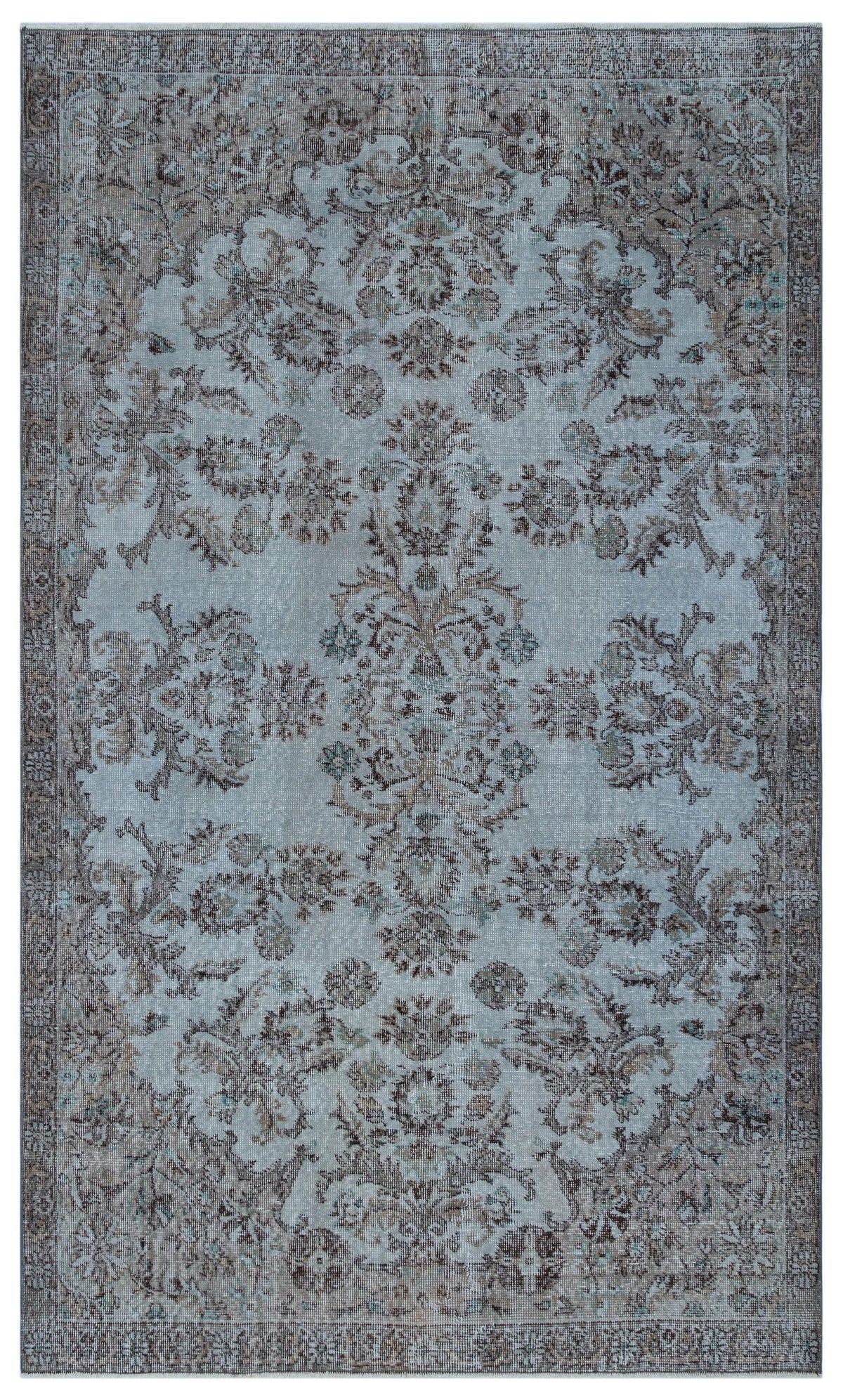 Light blue and brown vintage-style rug with a distressed floral medallion pattern and a decorative border.