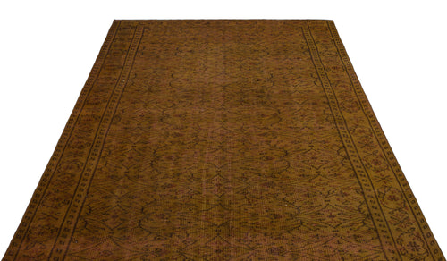 Load image 1 in gallery view. Dark brown vintage-style rug with a repeating geometric lattice pattern and a decorative floral border.