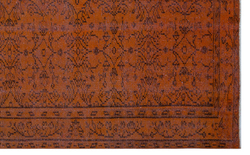 Load image 1 in gallery view. Rust-colored rug with a dark brown traditional floral medallion pattern and a geometric border.